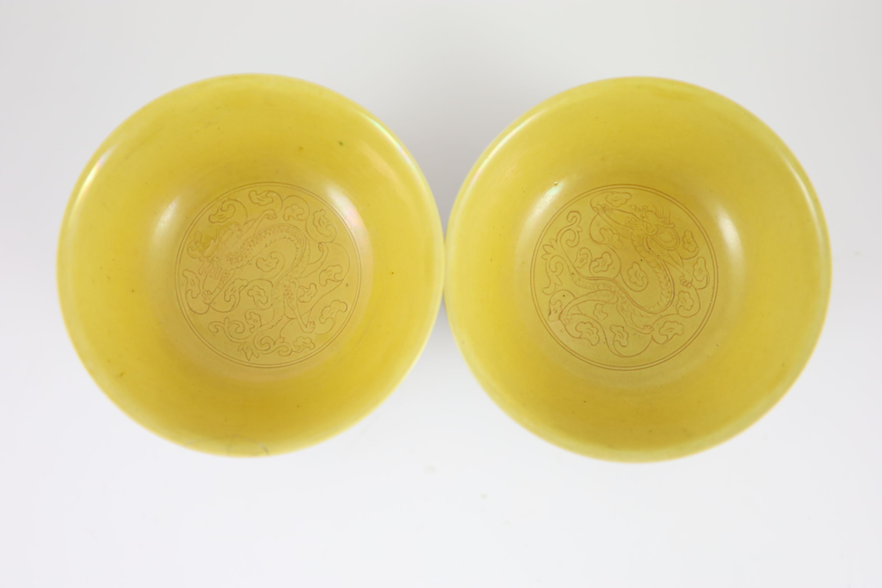 A pair of Chinese yellow ground sgraffito bowls, Kangxi mark but mid 20th century,